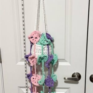 Handmade crochet hanging plant with pastel leaf accents